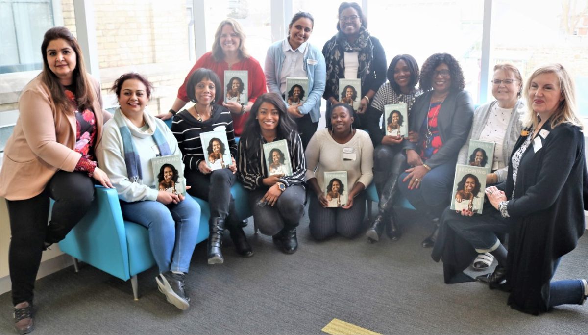 Visioning 2019 with group of women holding a copy of Michelle Obama's book Becoming